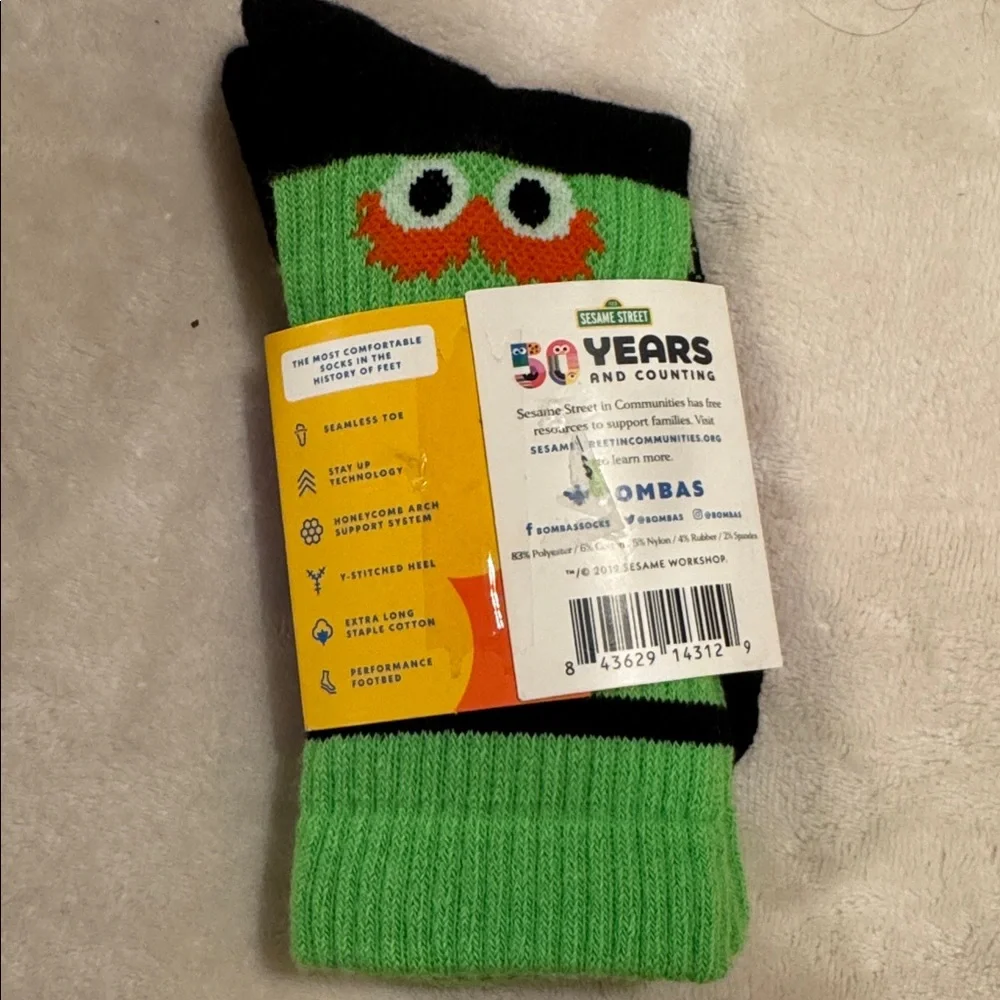 New pair of Bombas x Sesame Street youth crew socks in a black and green ELMO